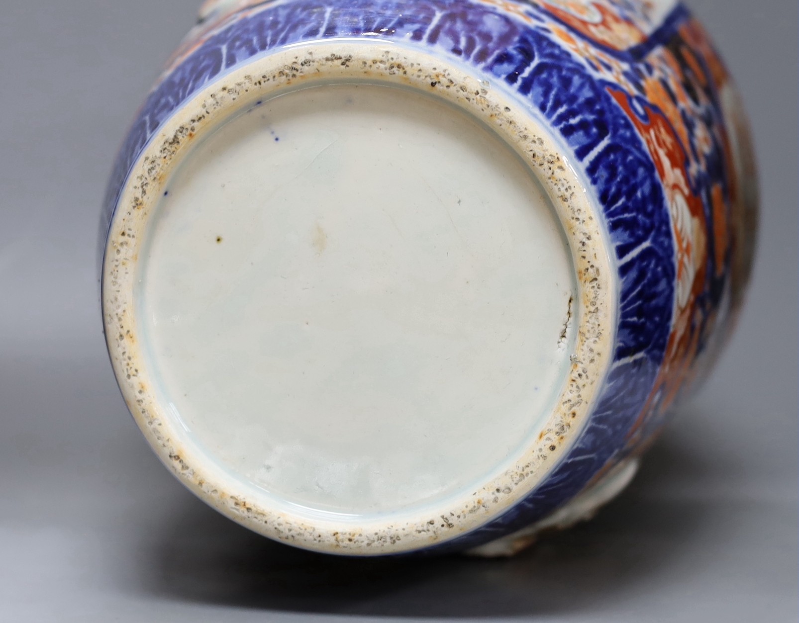 An unusual large Japanese Imari vase, Meiji period relief moulded with figures, 57cm tall, repairs